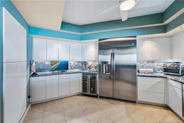 a kitchen with stainless steel appliances a sink and a refrigerator