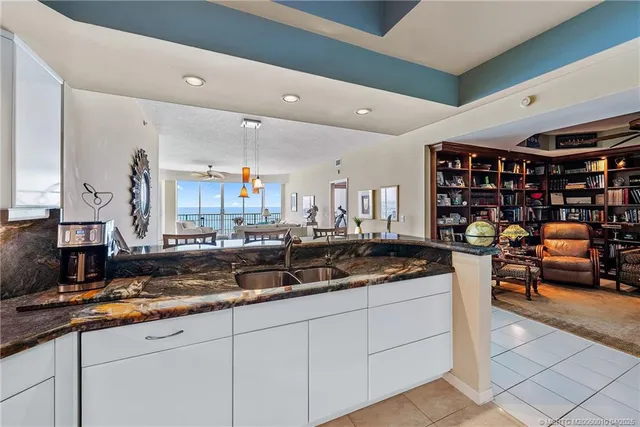 a kitchen with stainless steel appliances granite countertop a sink and cabinets