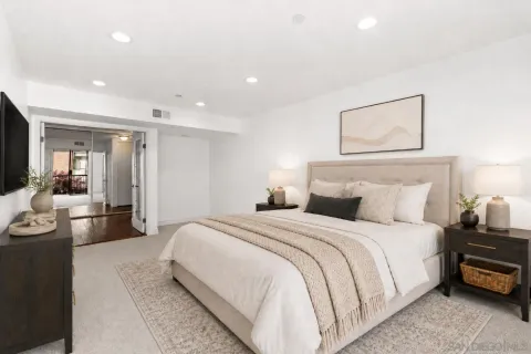 a spacious bedroom with a bed and glass wall