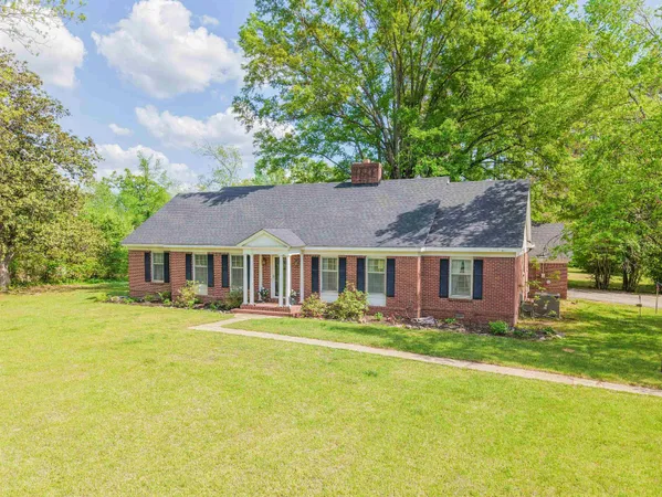 a front view of house with yard and green space