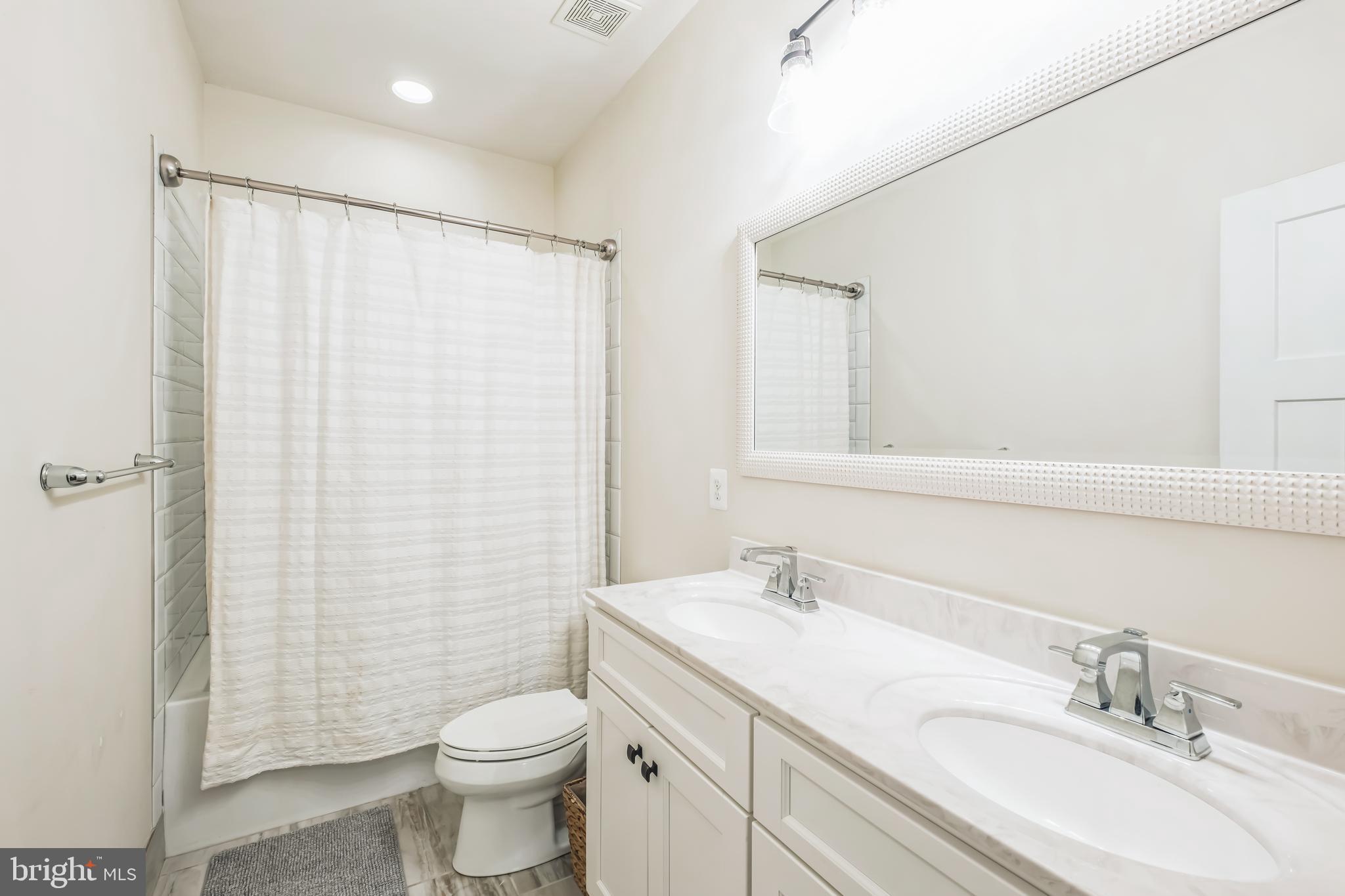 166 Nutwell Road Lothian, MD 20711 - Photo 20 of 29 a bathroom with a sink a toilet and shower curtain
