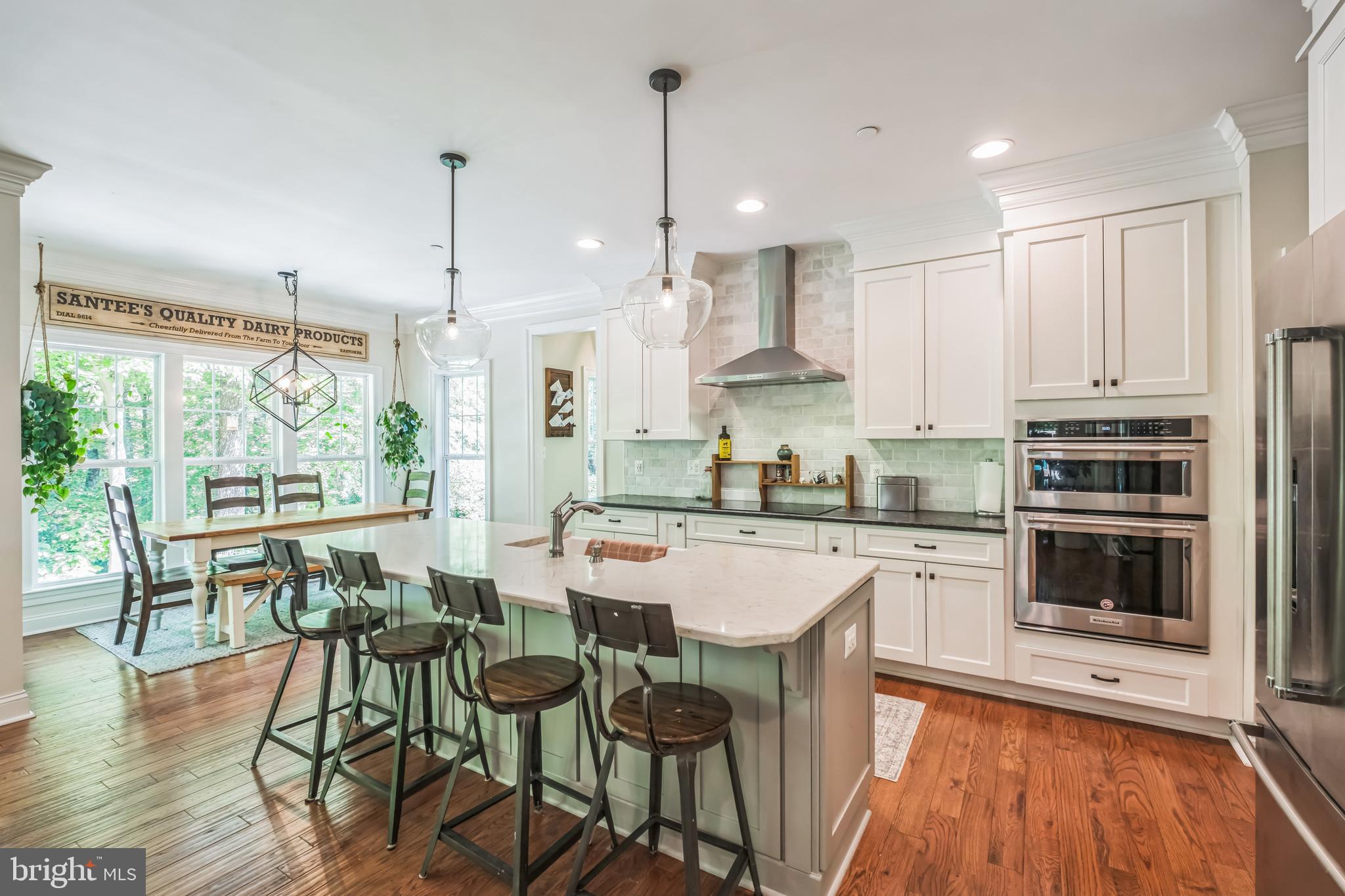 166 Nutwell Road Lothian, MD 20711 - Photo 5 of 29 a kitchen with stainless steel appliances granite countertop a stove a sink a microwave oven a refrigerator with white cabinets and wooden floor