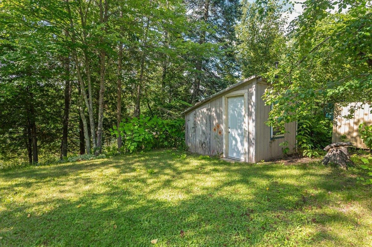 8977 Austin Road Alborn, MN 55702 - Photo 16 of 35 View of grassy yard featuring a storage unit