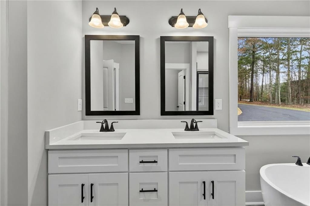 423 Relay Road Silver Creek, GA 30173 - Photo 29 of 48 a bathroom with double sink and a mirror