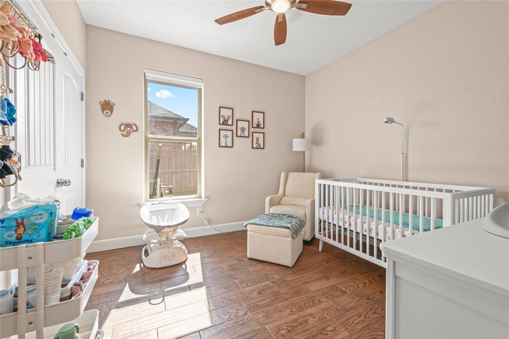 3801 Kady Ridge Abilene, TX 79606 - Photo 23 of 40 Wood-finish flooring, single window, ceiling fan, and a white paneled door