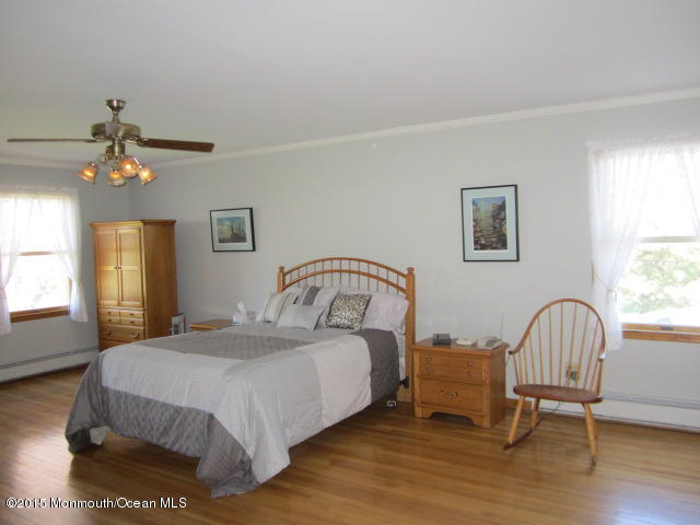 9 Georgetown Road Eatontown, NJ 07724 - Photo 23 of 33 a bedroom with a bed and a chair