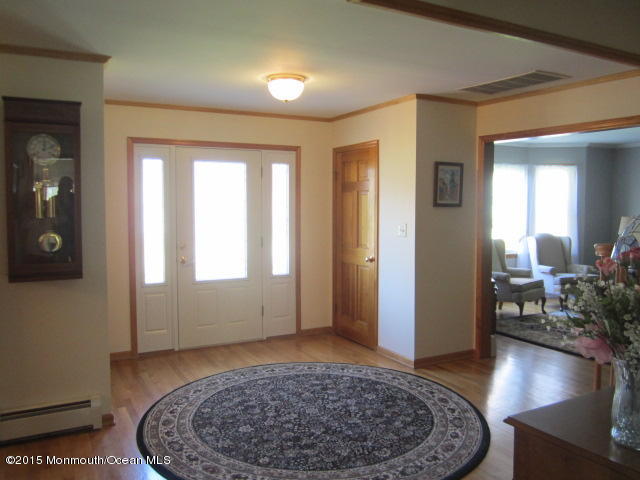 9 Georgetown Road Eatontown, NJ 07724 - Photo 4 of 33 wooden floor in an empty room with a mirror