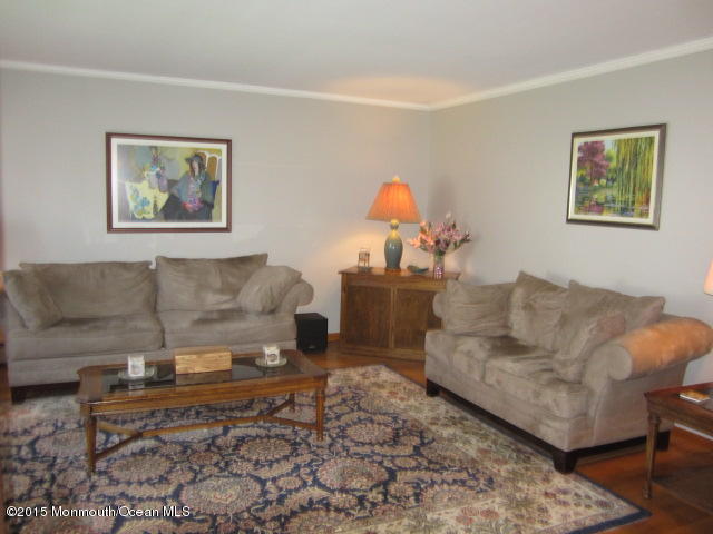 9 Georgetown Road Eatontown, NJ 07724 - Photo 7 of 33 a living room with furniture and a wooden floor