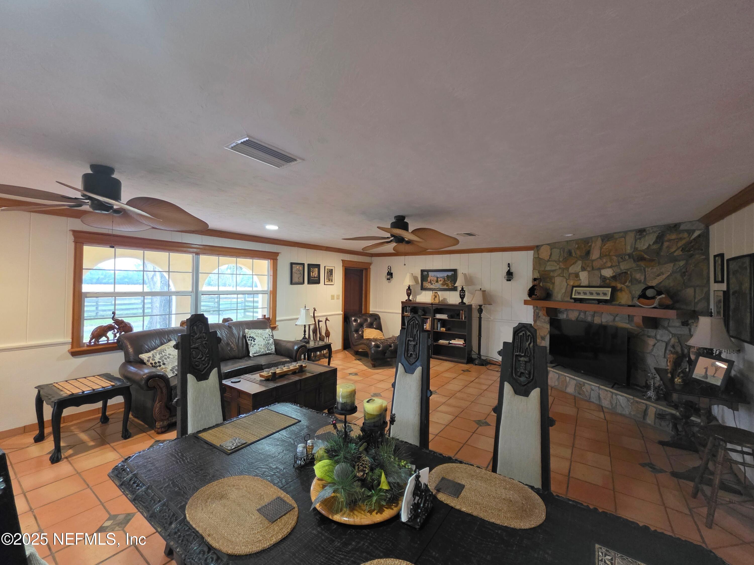 721 Bunnell Road Pierson, FL 32180 - Photo 12 of 59 a living room with lots of furniture and gym equipment