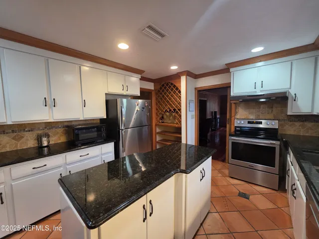 a living room with a couch and a stove top oven