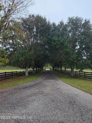a view of a livingroom with furniture and a large window