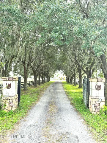 a kitchen with stainless steel appliances granite countertop a stove a sink a dining table and chairs with the cabinets