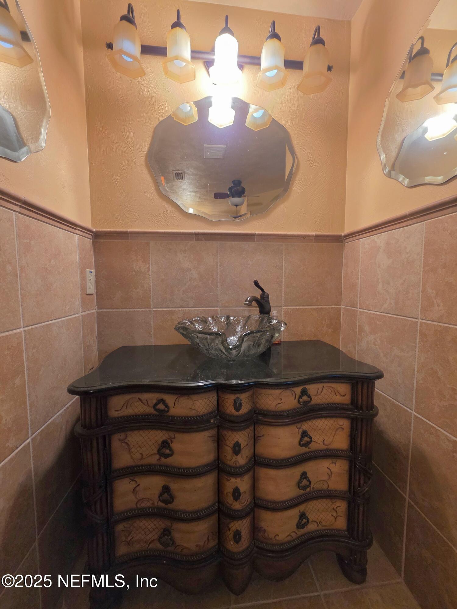 721 Bunnell Road Pierson, FL 32180 - Photo 33 of 59 a bathroom with a sink and mirror