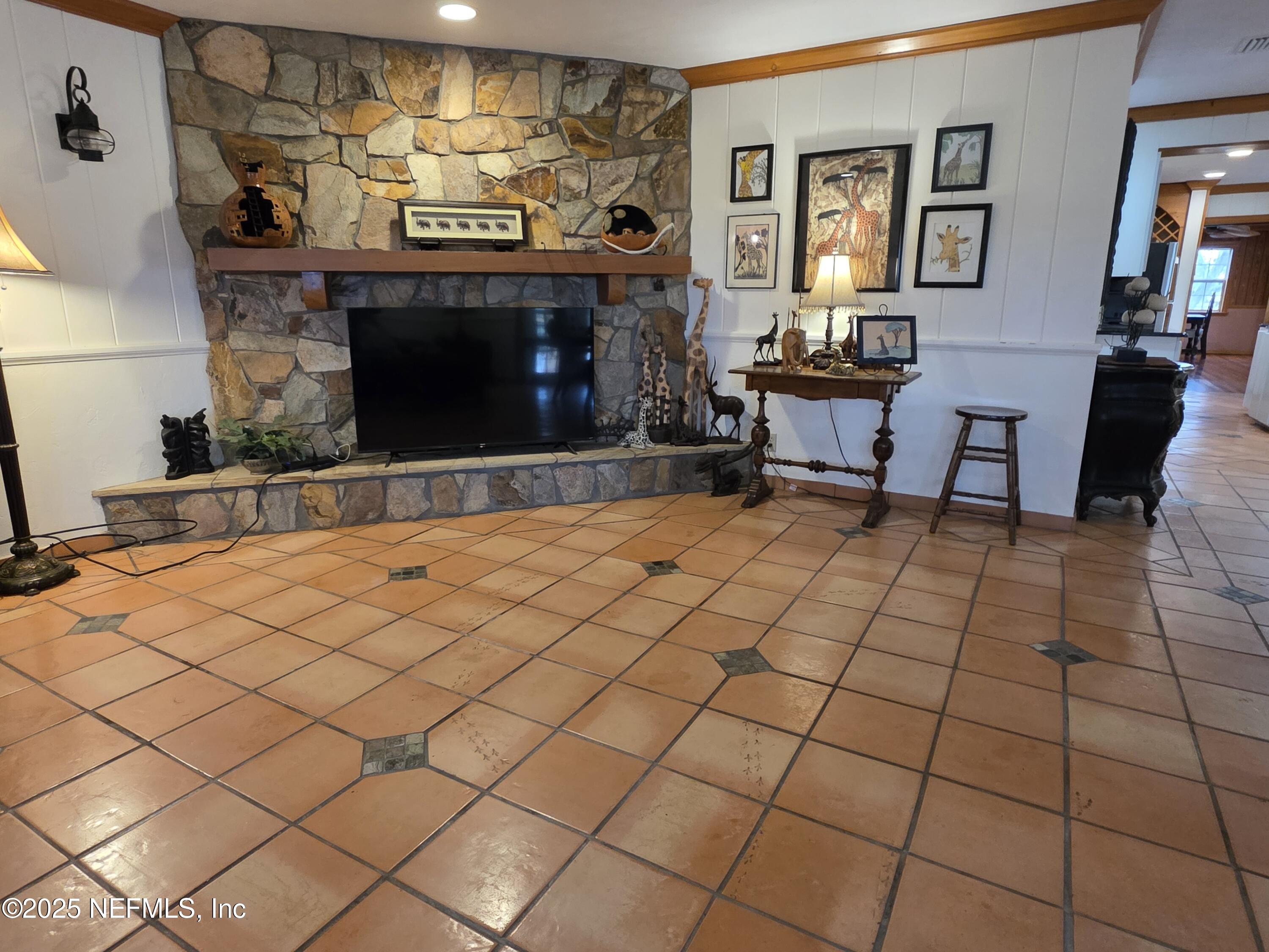 721 Bunnell Road Pierson, FL 32180 - Photo 8 of 59 a living room with a couch and a fireplace