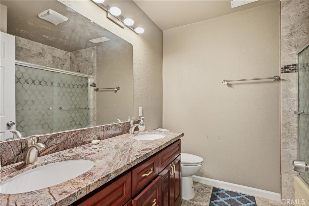 26200 Morgan Valley Road Lower Lake, CA 95457 - Photo 23 of 69 a bathroom with a granite countertop sink a toilet and a mirror