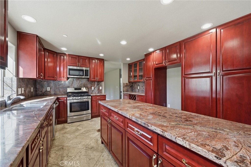 26200 Morgan Valley Road Lower Lake, CA 95457 - Photo 7 of 69 a kitchen with stainless steel appliances granite countertop refrigerator sink and stove
