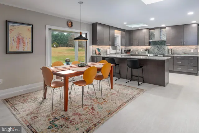 a kitchen with stainless steel appliances granite countertop wooden cabinets a refrigerator and a sink