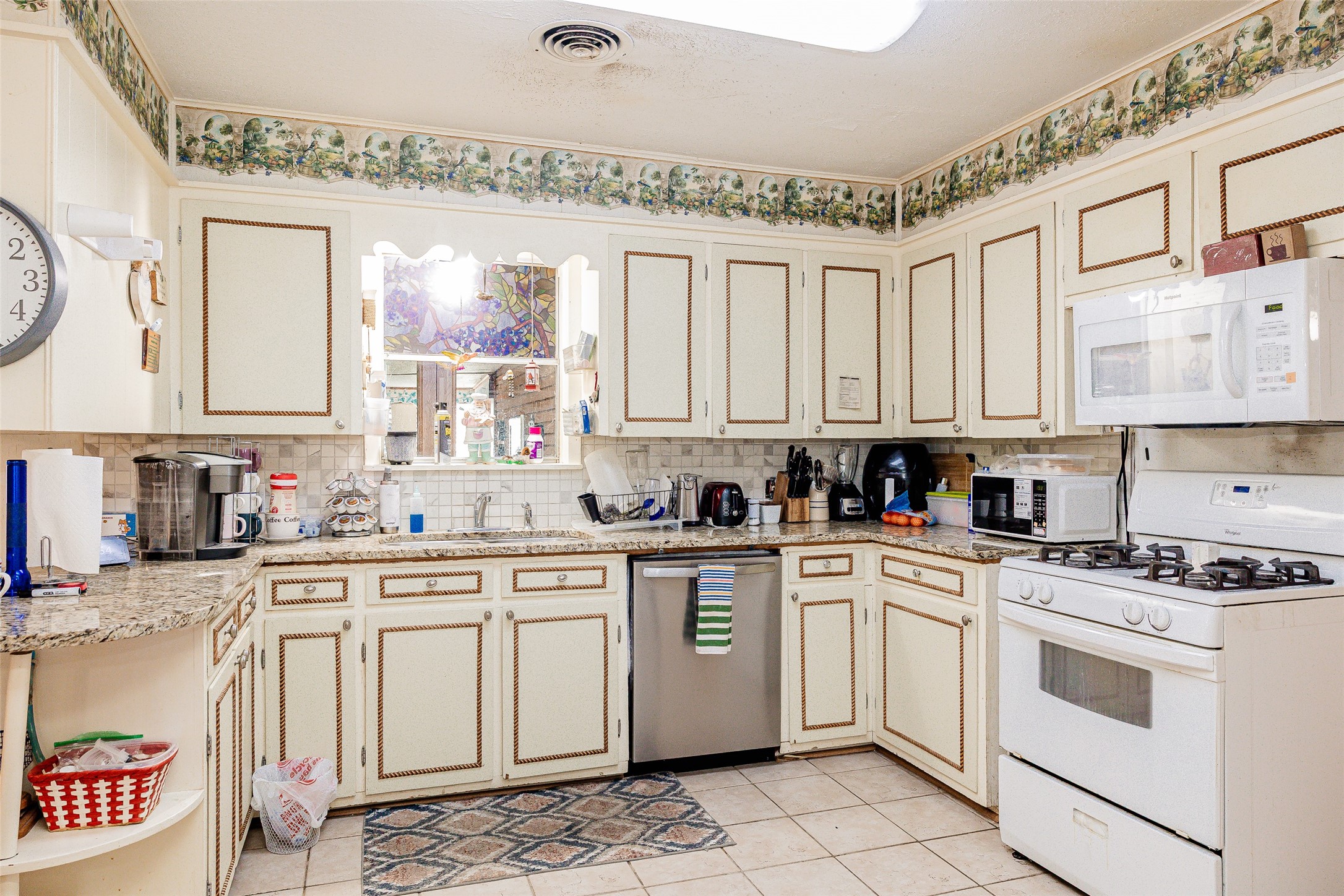 8608 Captain Scott Road Brenham, TX 77833 - Photo 4 of 28 a kitchen with white cabinets and white appliances