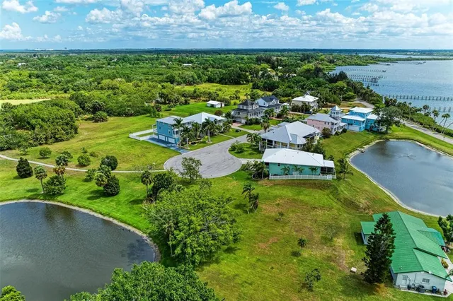 a view of a house with a garden and lake view