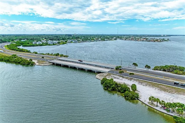an aerial view of a house with a yard and lake view