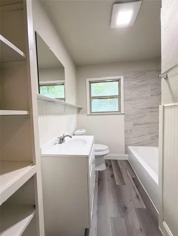 a bathroom with a sink a bathtub and a toilet