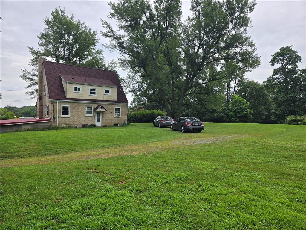 368 Pittsburgh Road Butler, PA 16002 - Photo 9 of 26 a car parked in the grass near a house