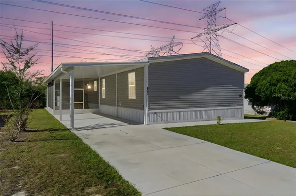 a view of a house with a small yard and plants