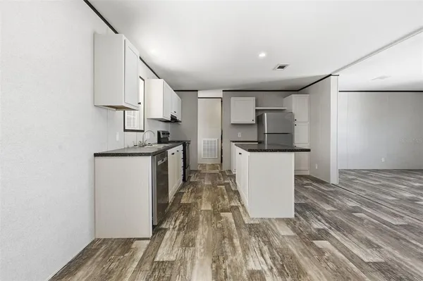 a kitchen with stainless steel appliances a refrigerator and a stove