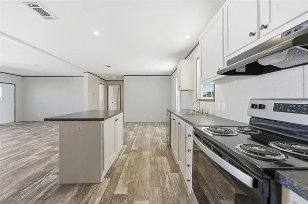 a kitchen with a stove and a refrigerator