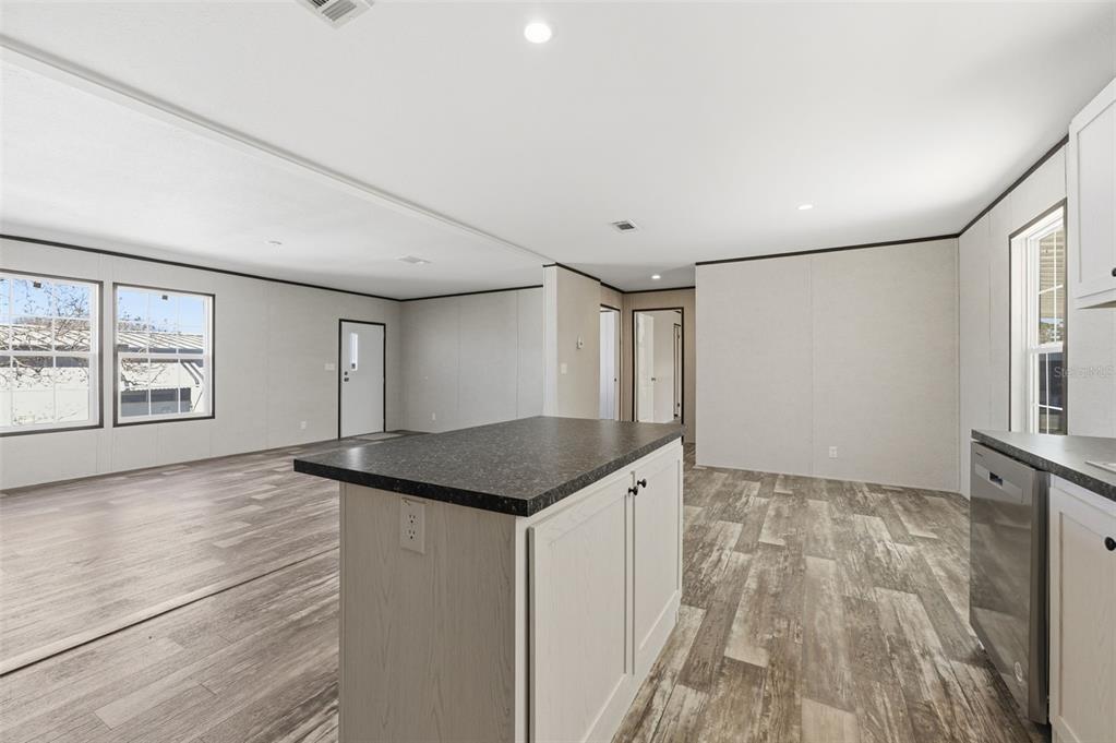 8551 Electra Avenue Brooksville, FL 34613 - Photo 15 of 54 wooden floor in an empty room with a window