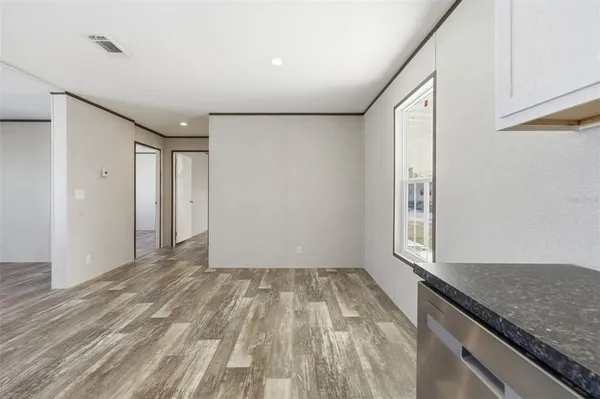 a view of hallway with natural light and hardwood