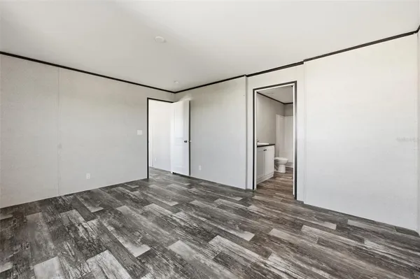 a view of a room with wooden floor