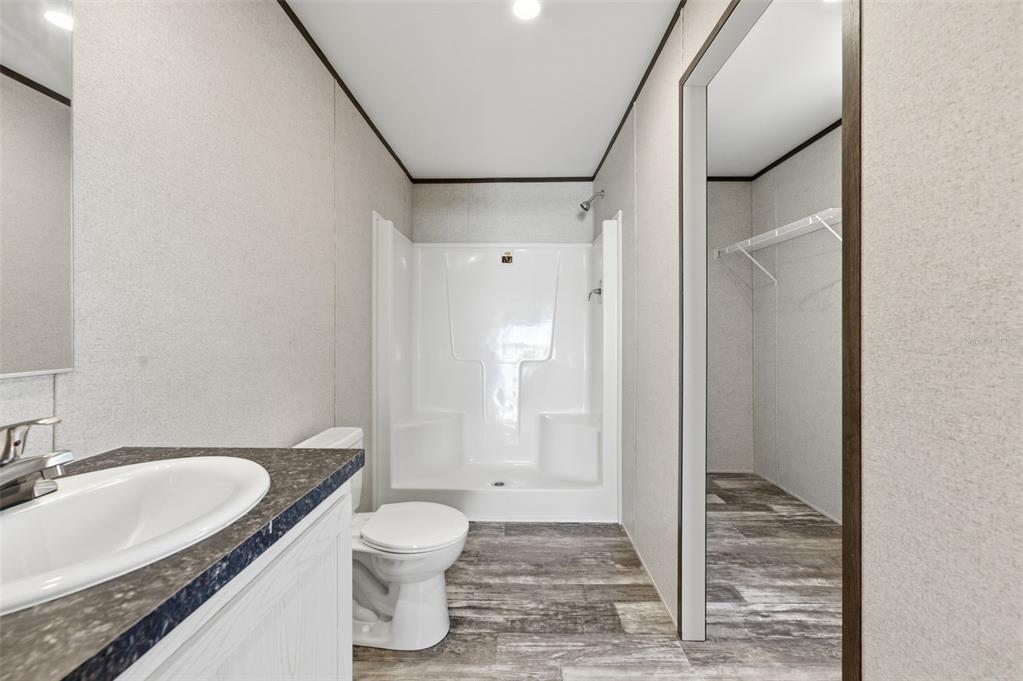 8551 Electra Avenue Brooksville, FL 34613 - Photo 32 of 54 a bathroom with a granite countertop sink toilet and shower