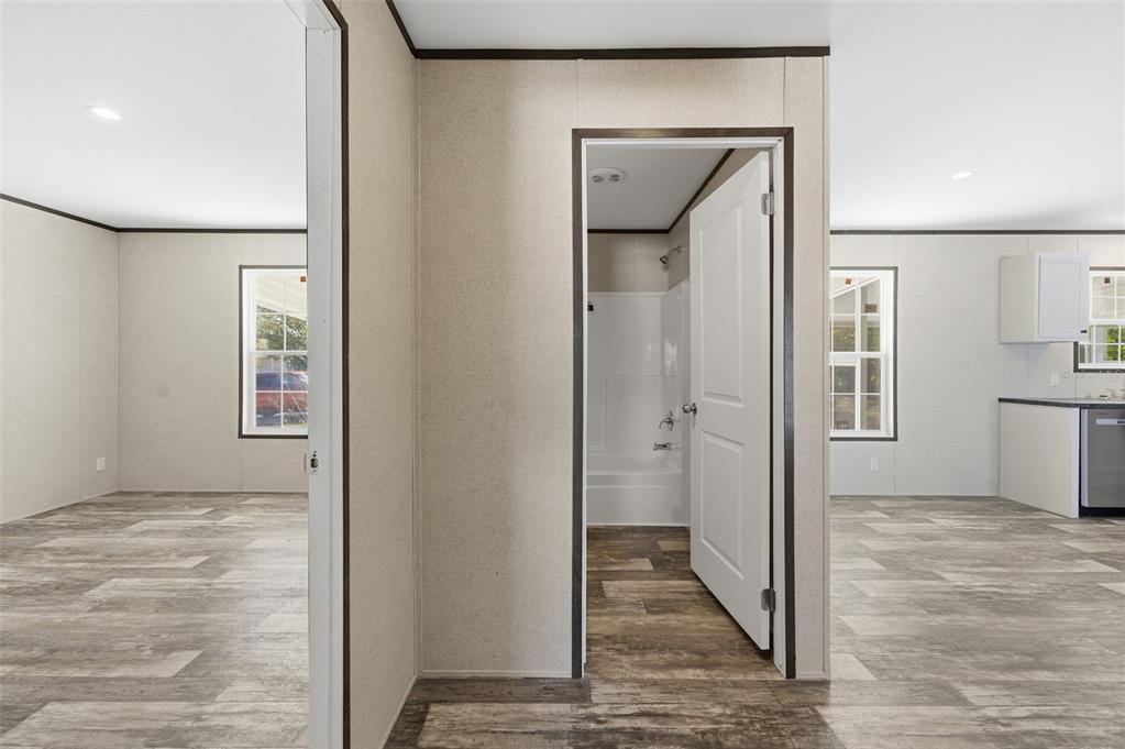8551 Electra Avenue Brooksville, FL 34613 - Photo 41 of 54 a view of a hallway with wooden floor and staircase