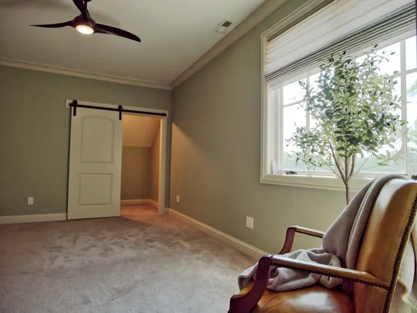 a view of staircase with lots of frames on wall and a window