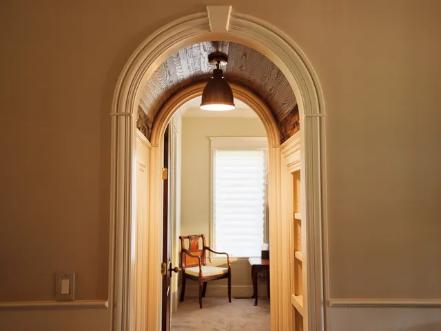 a bedroom with bed and a large window
