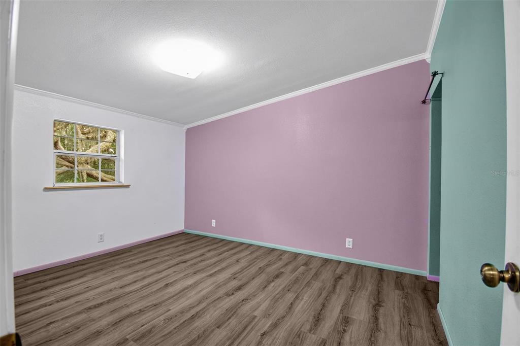 156 Kingfish Road Pomona Park, FL 32181 - Photo 40 of 55 an empty room with wooden floor and windows