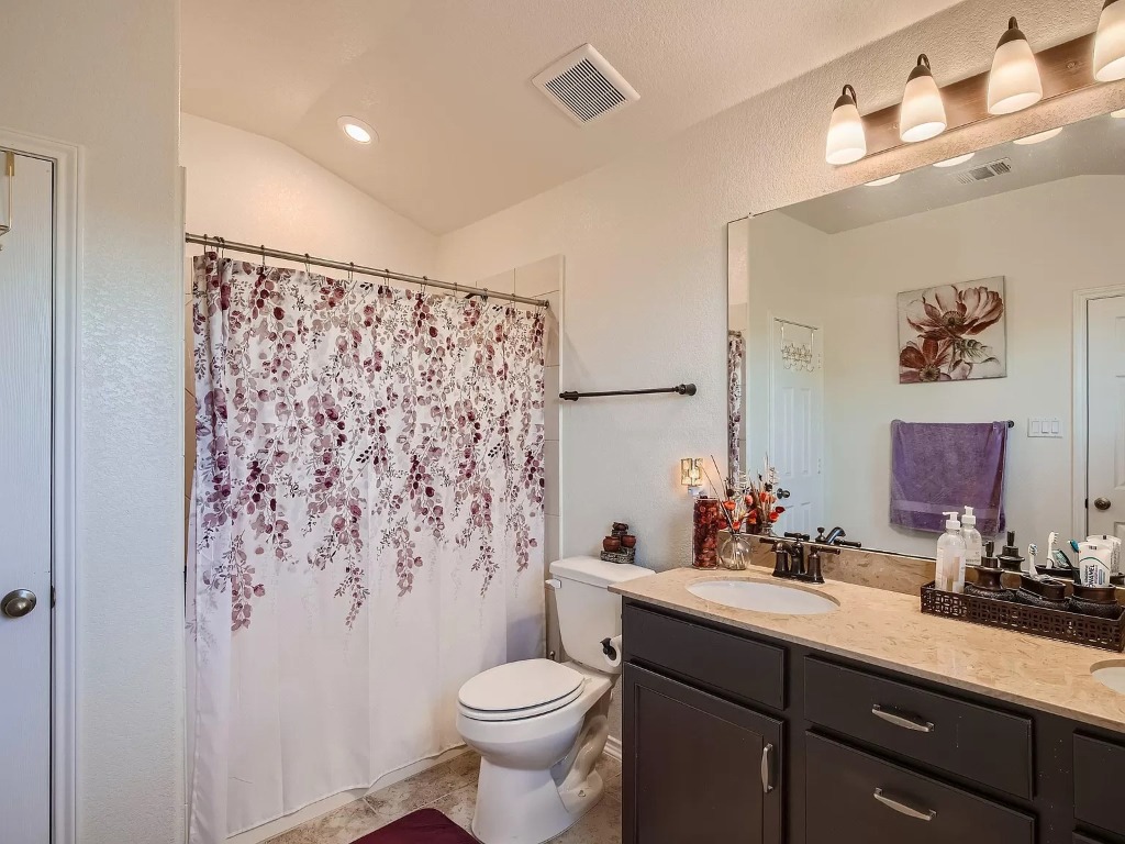 2471 Sunrise Road, Unit 64 Round Rock, TX 78664 - Photo 14 of 30 a bathroom with a sink toilet and shower