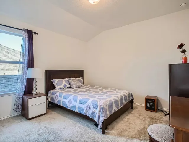 a bathroom with a granite countertop sink a toilet a mirror and shower