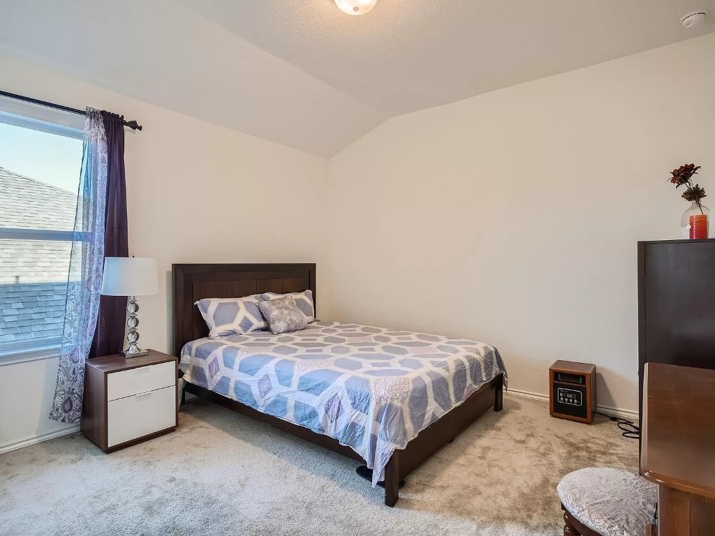 2471 Sunrise Road, Unit 64 Round Rock, TX 78664 - Photo 19 of 30 a bedroom with a bed couch and a large window