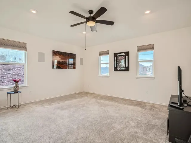 a view of a livingroom with furniture and a ceiling fan
