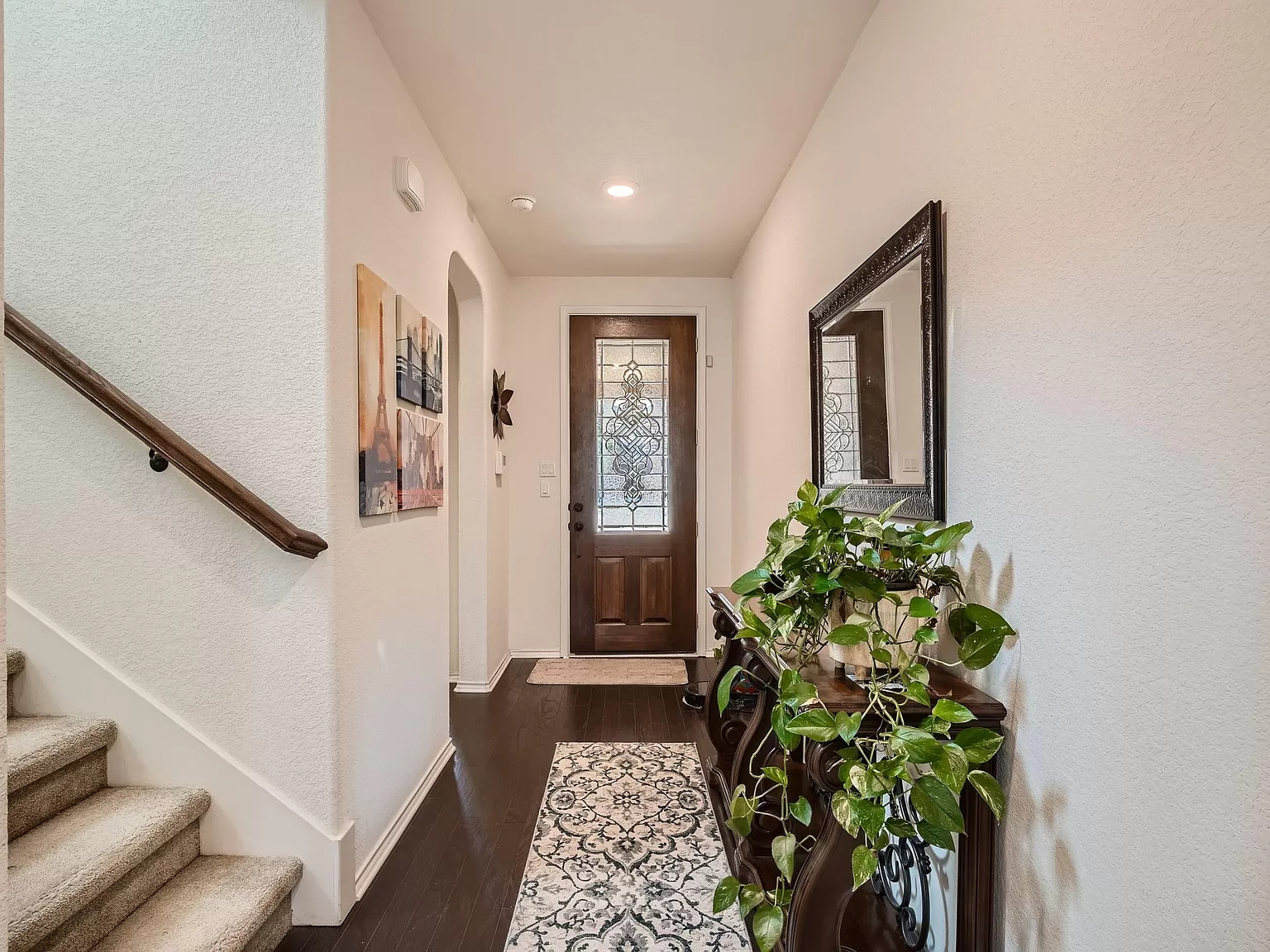 2471 Sunrise Road, Unit 64 Round Rock, TX 78664 - Photo 7 of 30 a hallway with wooden floor and a potted plant