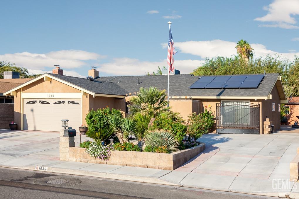 a view of a house with a yard and potted plants