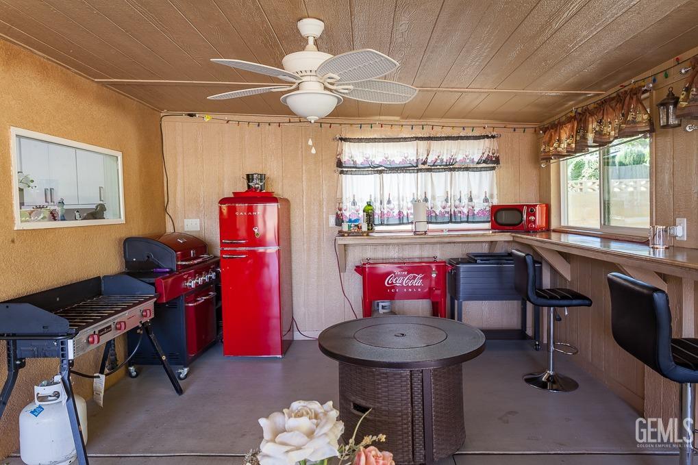Undisclosed Address Ridgecrest, CA 93555 - Photo 18 of 23 a kitchen with a stove a refrigerator and a dining table