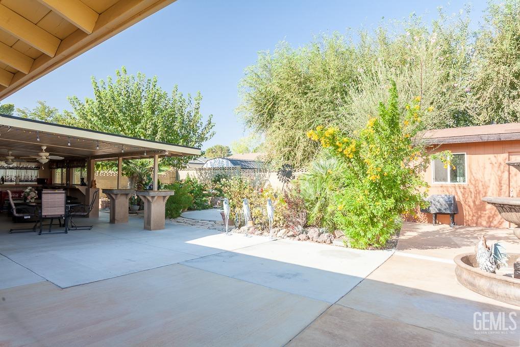 Undisclosed Address Ridgecrest, CA 93555 - Photo 20 of 23 a view of a patio with table and chairs under an umbrella