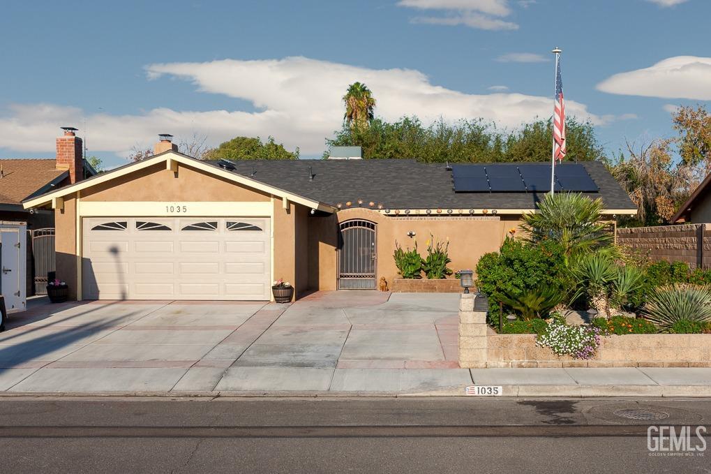 Undisclosed Address Ridgecrest, CA 93555 - Photo 2 of 23 a front view of a house with a yard and garage