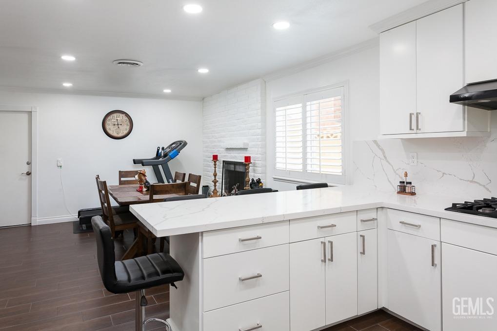 Undisclosed Address Ridgecrest, CA 93555 - Photo 9 of 23 a kitchen with a table chairs a stove a sink and a window