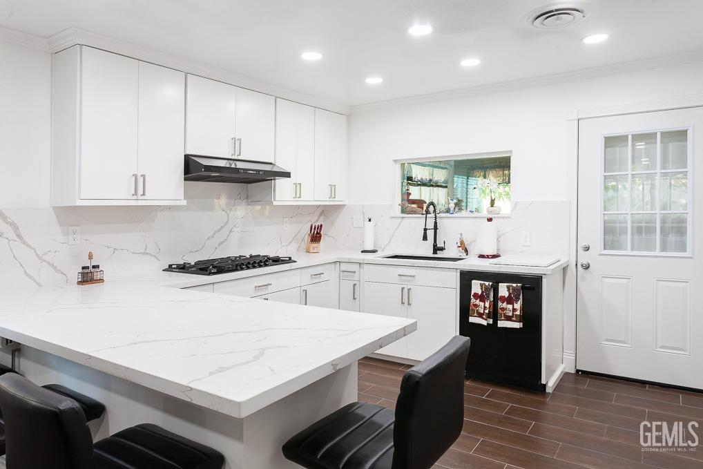 Undisclosed Address Ridgecrest, CA 93555 - Photo 10 of 23 a kitchen with kitchen island a stove a sink and a refrigerator