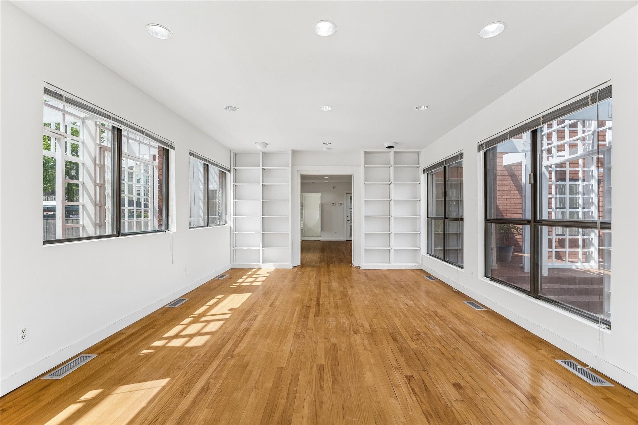 2402 Commonwealth Street Houston, TX 77006 - Photo 29 of 45 a view of an empty room with a window and wooden floor