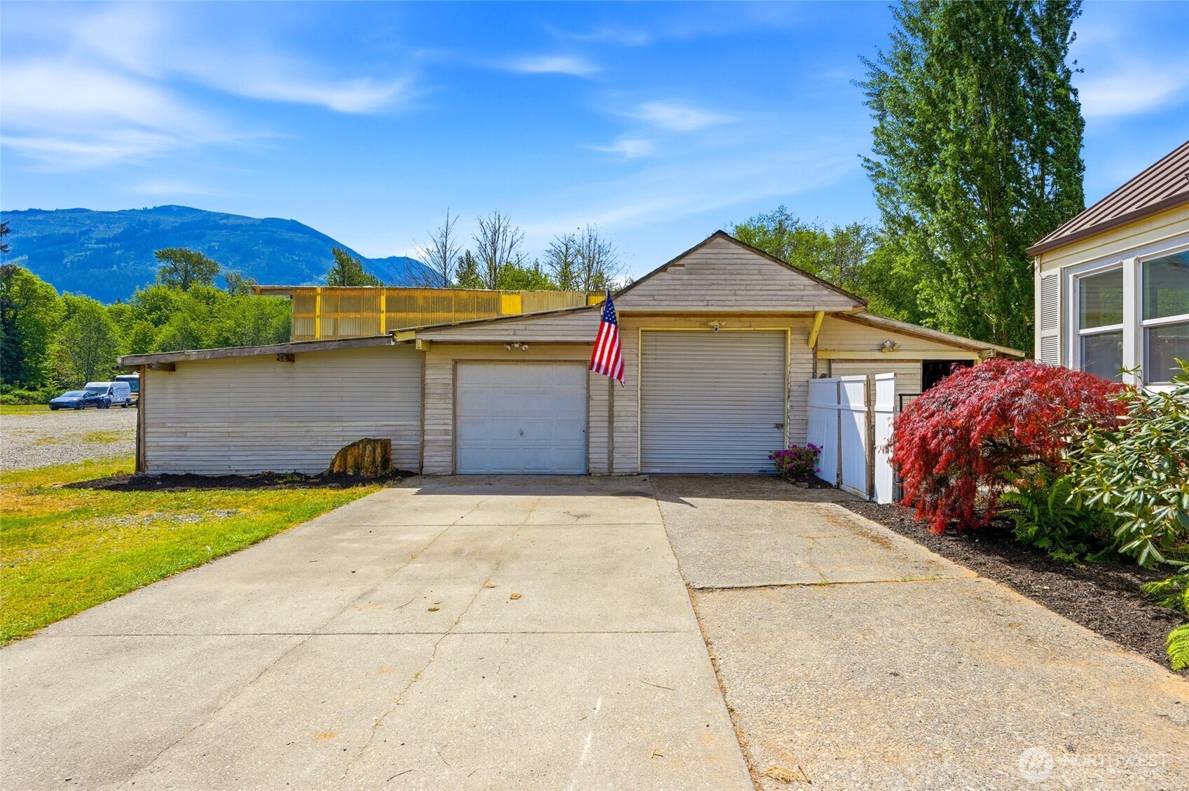 21716 State Rte 530 Northeast Arlington, WA 98223 - Photo 26 of 38 a front view of a house with a yard and garage
